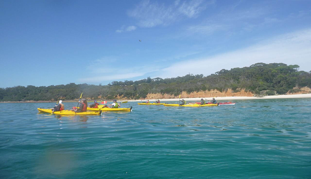 A sea kayaking group paddling together in Jervis Bay